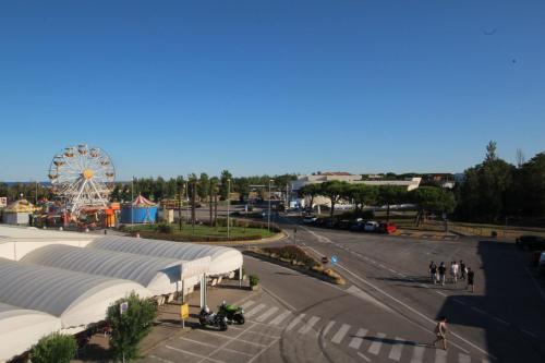 a view of a city with a ferris wheel at Ohana Holiday Rooms in Rosolina Mare