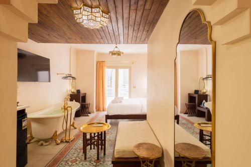 um quarto com uma cama, uma banheira e um lavatório em The Majestic Marrakesh Studio Cairo's Downtown no Cairo
