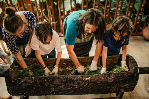 a group of people looking at plants in a table at Heaven Restaurant & Boutique Hotel in Kigali