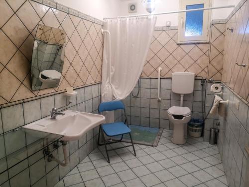 a bathroom with a sink and a toilet at Camping Almoetia in Calatabiano