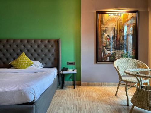 a bedroom with a bed and a table and chairs at VIA VARANASI-A Boutique Hotel in Varanasi