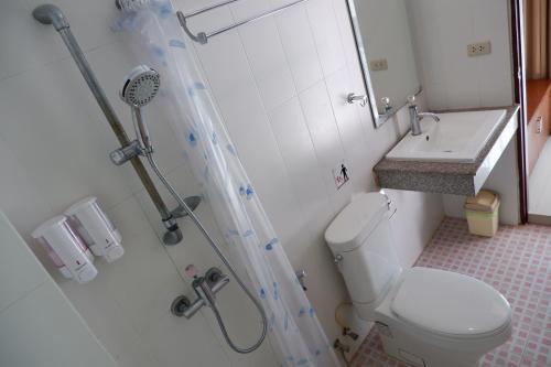 a bathroom with a toilet and a sink at Kata Beachwalk Hotel and Bungalows in Kata Beach