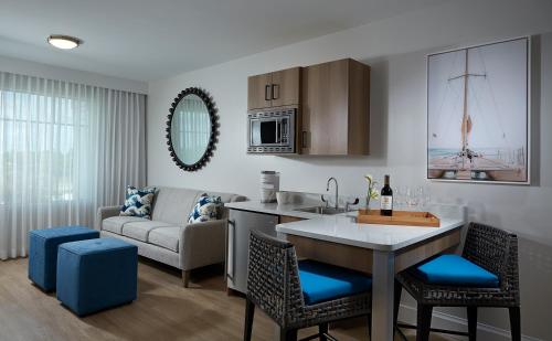 a kitchen and living room with a table and a couch at The Pointe Hotel in Jupiter