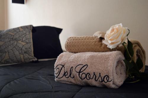 a bed with a towel with a flower on it at Le Case di Sonia DEL CORSO CIV 25 Fucecchio in Fucecchio