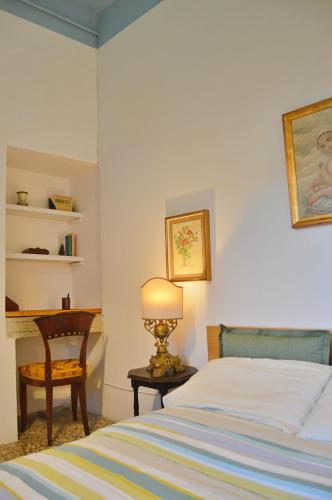 Postel nebo postele na pokoji v ubytování Palazzetto Scodellari