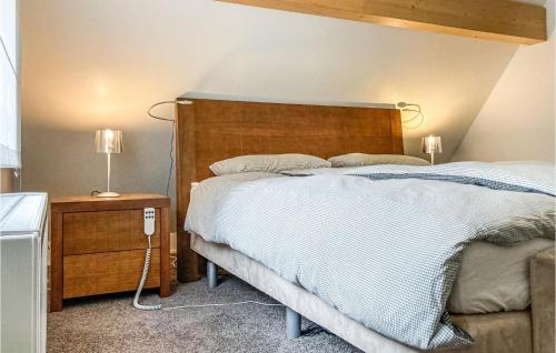 1 dormitorio con 1 cama grande y cabecero de madera en 2 Bedroom Gorgeous Home In Rekem-lanaken en Bovenwezet