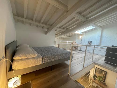 a small bedroom with a bed and a balcony at Corte Santa Caterina in Florence in Florence
