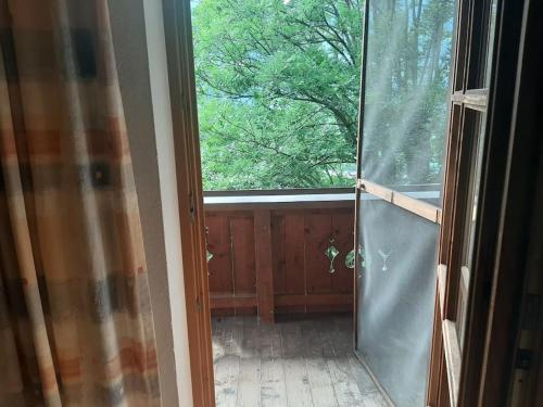a glass door leading into a room with a window at Alpine cottage with exceptional view in Mayrhofen
