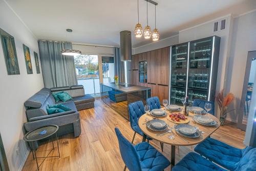 a living room with a table and blue chairs at Apartament w Cieplicach 7 Relax in Jelenia Góra