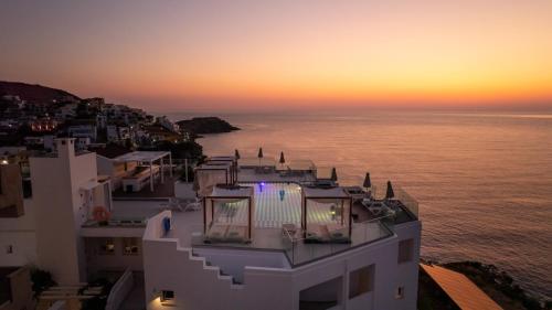 a view of the ocean from a building at sunset at Blue Bay Lifestyle - ex Bali Blue Bay in Balíon