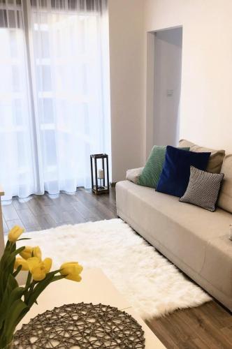 a living room with a couch and a table at Apartament Active Moon in Lublin