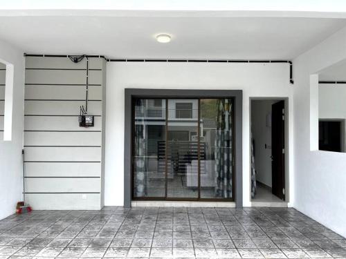 a front door of a white house with a window at Azzalea Homes 6 @ Taman Golden Hills Cameron Highlands in Tanah Rata