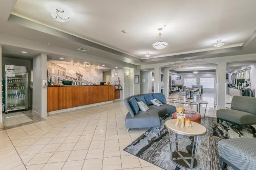 a living room with a couch and a table at La Quinta by Wyndham Granbury in Granbury
