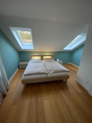 a bedroom with a bed and two skylights at Ferienwohnung Brigitte in Goldkronach