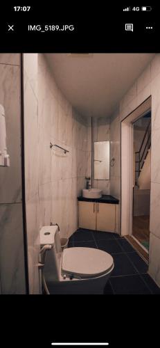 a bathroom with a toilet and a sink at Suite Princess Beach Resort in Siquijor