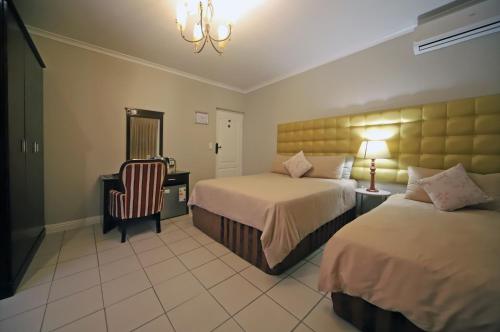 מיטה או מיטות בחדר ב-Savoy Lodge