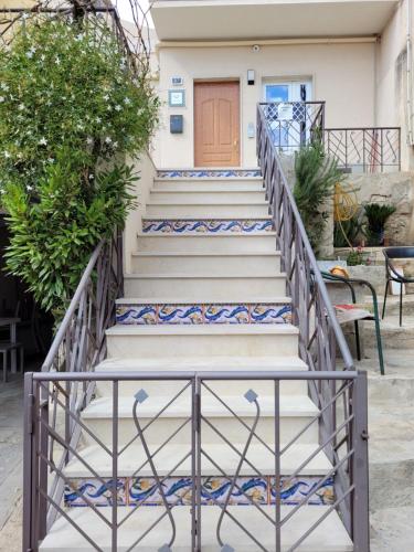 a set of stairs with blue and white tiles at Casa Alecci 1820 in Modica