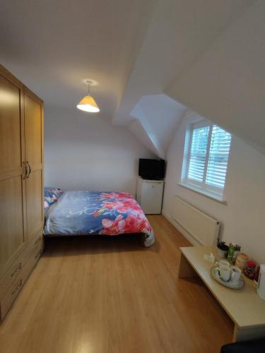 a bedroom with a bed in a attic at Ash Lawns in Bolton