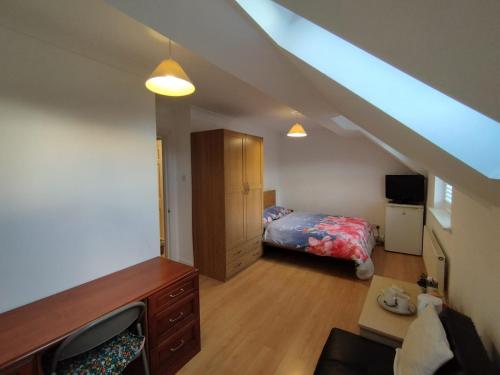 a attic room with a bed and a bed sqor at Ash Lawns in Bolton