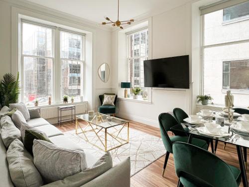 a living room with a couch and a table at Large Blythswood Residence in Glasgow