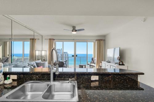a kitchen and living room with a view of the ocean at Ariel Dunes I 1705 in Destin