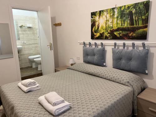 a bedroom with a bed with two towels on it at B&B San Michele a Porta Pia in Rome