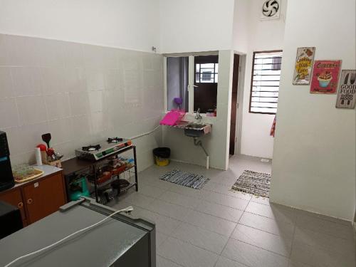 a room with a room with a desk and a room with a room at Homestay Jerantut Sincerelyat in Jerantut