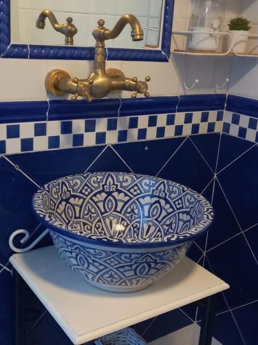 a bathroom sink with a gold faucet next to a sink at Guesthouse Jazmínes Mozárabes # WIFI in Baena