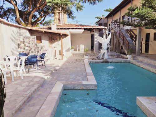 a pool with a fountain in the middle of a house at Pousada Praia De Ponta Negra in Natal