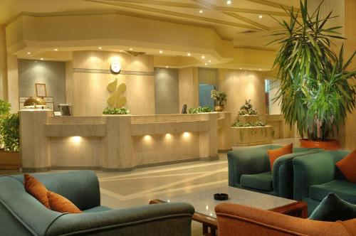 a lobby with blue chairs and a waiting room at Resta Port Said Hotel in Port Said