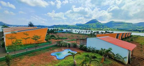 a building with a painting on it next to a river at Mountain N Lake Resort in Igatpuri