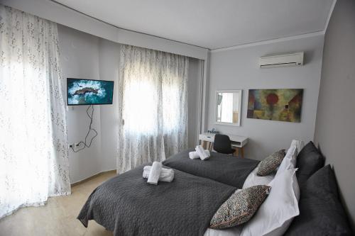 A bed or beds in a room at C.L.A. 2 City Lux Apartment Alaxandroupoli