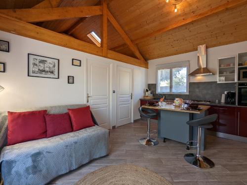 a living room with a couch and a desk at LANA COTTAGE 3 Etoiles in Montjean