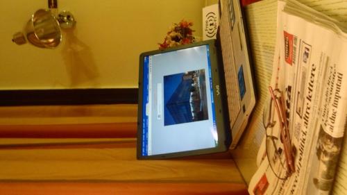 a picture frame sitting on a shelf with books at Hotel Cristal Eboli in Eboli