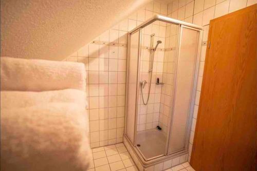 a shower with a glass door in a bathroom at Gemütliches Apartment im wunderschönen Kallmünz in Kallmünz