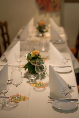 a long table with wine glasses and a laptop on it at Hotel Leyscher Hof in Leutesdorf