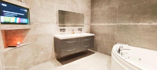 a bathroom with a sink and a toilet and a tub at First floor Flat 1 Northwood in London