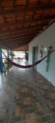 a hammock hanging from the ceiling of a building at Suits - Canto do sabia in Brotas