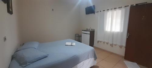 a bedroom with a bed with two candles on it at Suits - Canto do sabia in Brotas