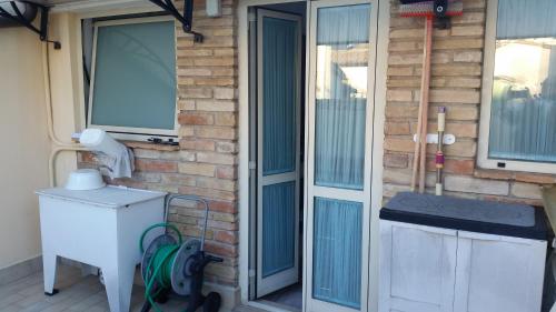 a door of a house with a refrigerator and a window at Affittacamere Il Giramondo in Foligno