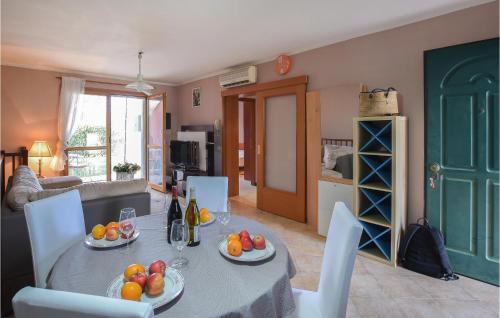 a living room with a table with fruit on it at Nice Apartment In Aprilia Marittima in Aprilia Marittima