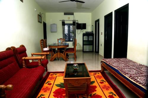 a living room with a couch and a table at Colonia Munnar Homestay in Munnar