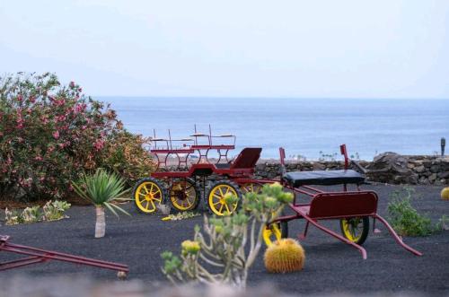 a couple of carts parked next to the ocean at Club JM Lanzarote in Tabayesco