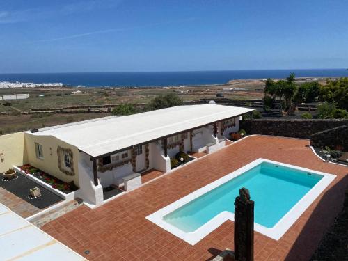 a house with a swimming pool on a roof at Club JM Lanzarote in Tabayesco