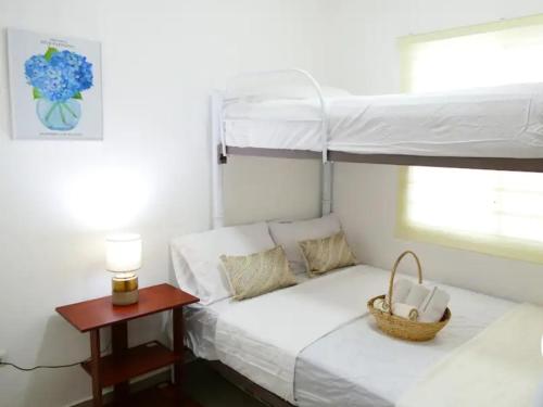 a bedroom with a bunk bed with a basket on it at Ecusuites Playas House VI Resort Altamarll Piscina Playa in Playas