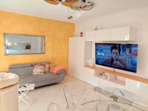 a living room with a couch and a flat screen tv at Da GianFi Lugano-Pregassona - Stanza privata - Adults Only in Lugano
