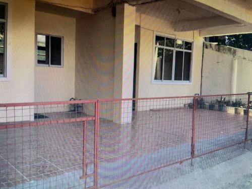 a building with a fence in front of it at S & E homes 2 in Babuy