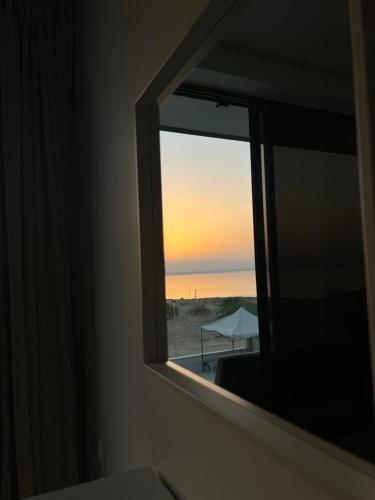 a window with a view of the beach at Follow Sea Villa in Sowayma