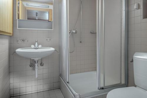 a bathroom with a shower and a sink at Tschiffra EG in Bettmeralp