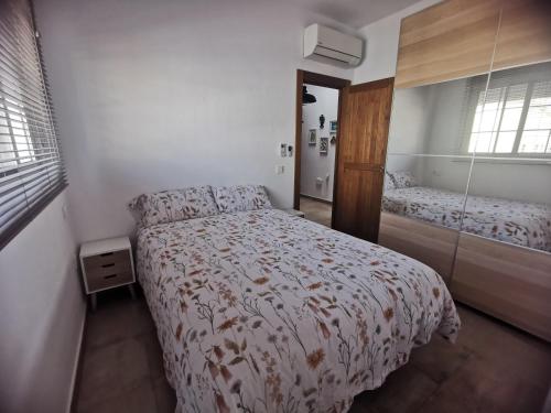 a small bedroom with a bed and a bathroom at Botavara in El Cabo de Gata